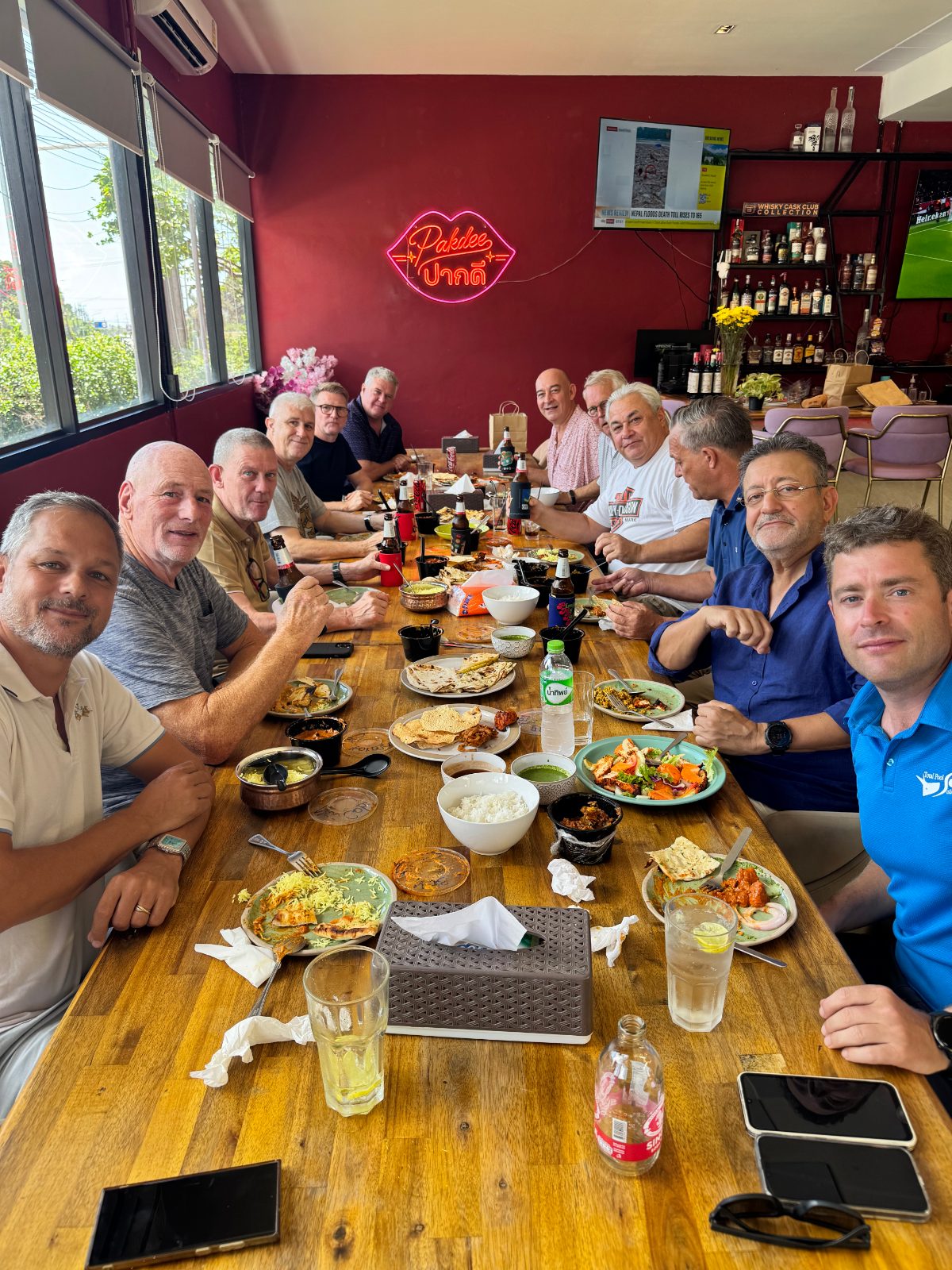 Curry Club guests sharing lunch at a long table